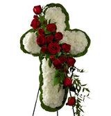 Funeral flower cross on stand with white carnations and red roses
